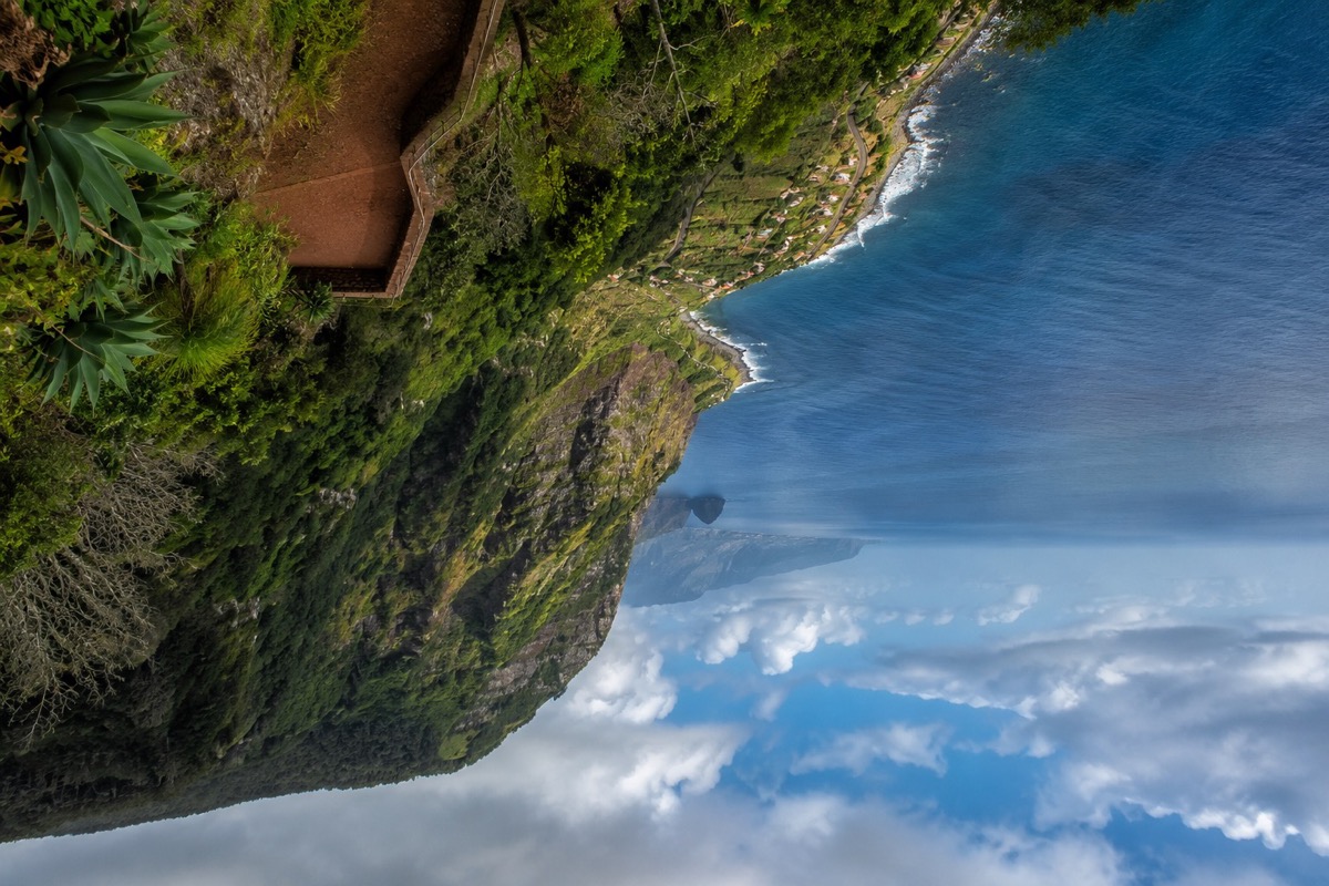 Grüne Vulkanlandschaft am Atlantik mit Küste, Wolken und weitem Meerblick.